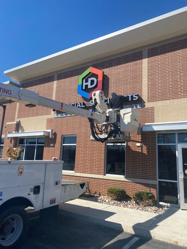 Channel letter sign repair on a logo sign