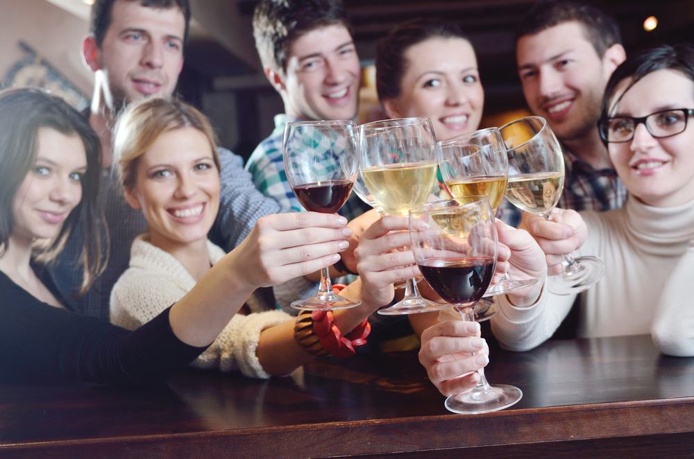 Group of happy young people drink wine at party disco restaurant