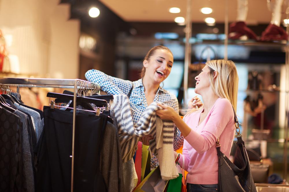 happy young girls in shopping mall, friends having fun together